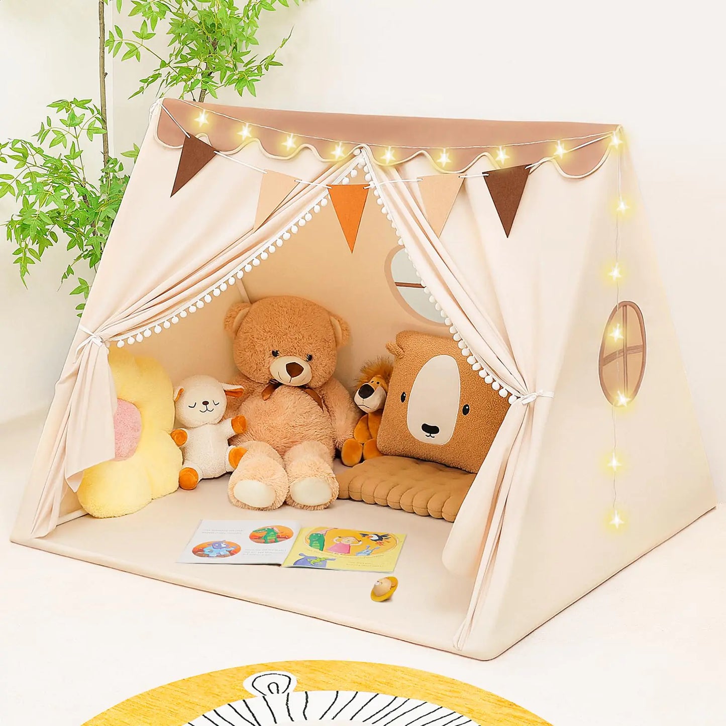 Children's play tent with teddy bear, plush toys, and decorative lights in a room setting.